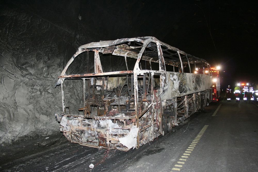 Turistbussen som tirsdag begynte å brenne inne i Gudvangatunnelen, ble onsdag fraktet ut. Bussen tilhører et busselskap som kjørte på oppdrag for det svenske selskapet Ellös Buss i Göteborg, opplyser selskapet. Foto: Arne Veum / NTB scanpix
