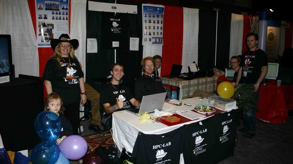 Anne C. Elster med åtte diplomstudenter og en stipendiat på  SC'08-stand.hele hovedkommiteen som arrangerer SC&acute;08Som medlem i hovedkomiteen er Elster iført cowboyhatt for anledningen.