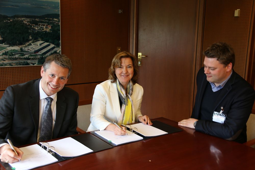 IBMs norgessjef Arne Norheim signerer kontrakten med Ann Mari Ågotnes, økonomidirektør i Schibsted Norge.