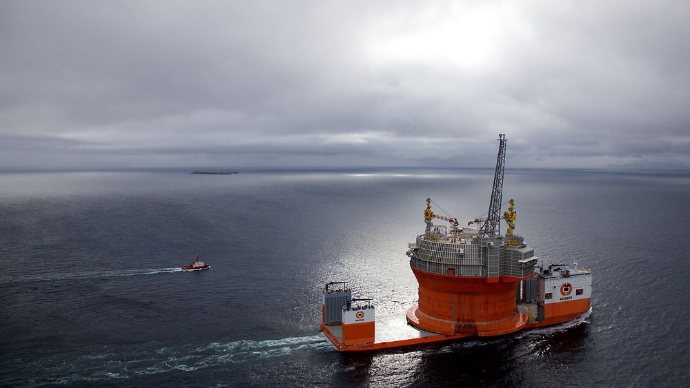 Sola presser seg gjennom skylaget idet Dockwise Vanguard og Goliat seiler inn fjorden mot Hammerfest. Foto: Eirik Helland Urke