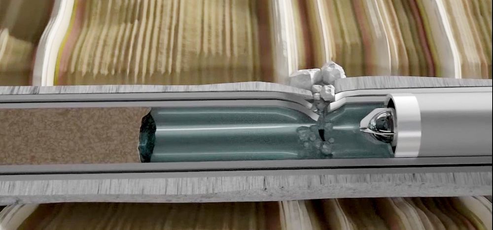 Her ser man en illustrasjon av kameraet til høyre og den klare væsken som blir skjøvet foran kameraet for å gjøre det mulig å ta bilder.