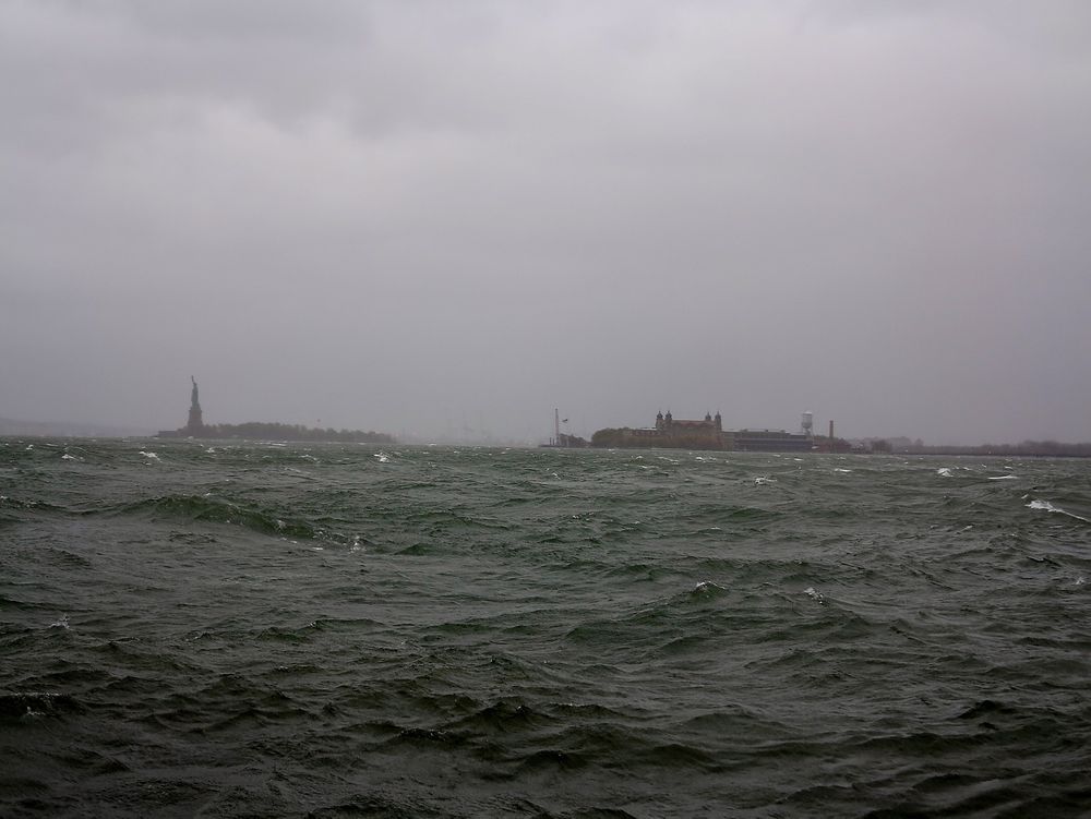 STANDHAFTIG: Frihetsgudinnen og Ellis Island har ikke opplevd maken til storm siden 1903. Vannstanden steg raskt utover mandagen. Fullmåne bidrar til springflo.            