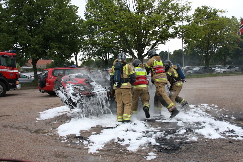 VELTET: Brannmannskaper tipper den utbrente ulykkesbilen over på det som er igjen av hjulene før bergingsbilen fjerner vraket.