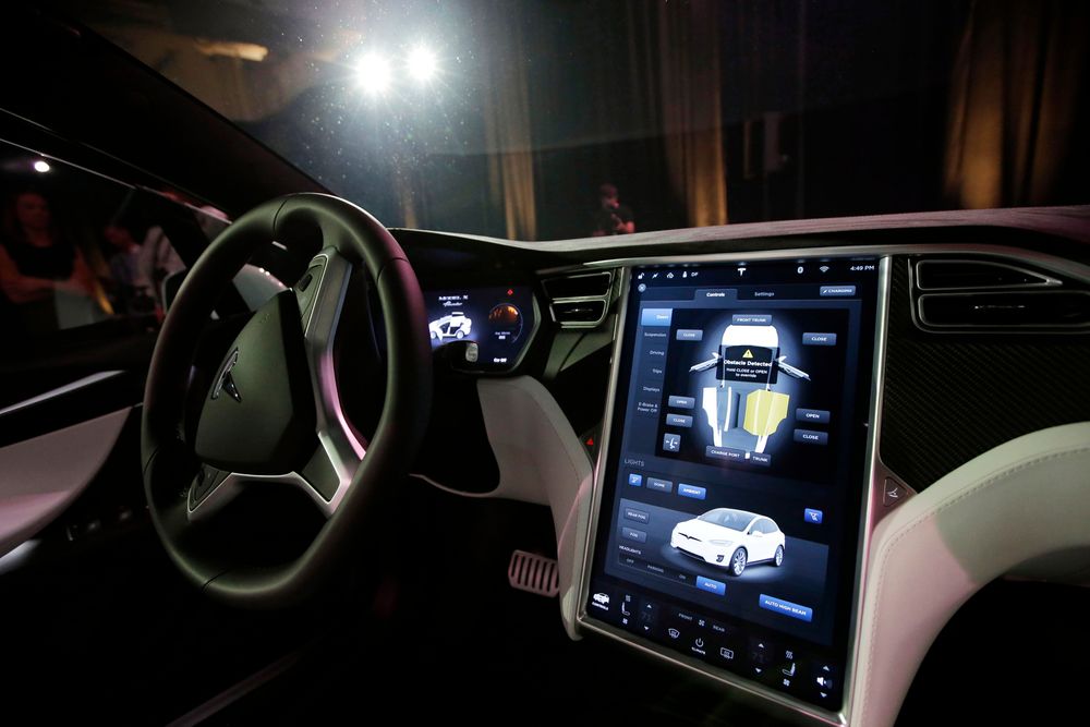 The dashboard of the Tesla Model X car is shown at the company's headquarters Tuesday, Sept. 29, 2015, in Fremont, Calif. CEO Elon Musk said the Model X sets a new bar for automotive engineering, with unique features like rear falcon-wing doors, which open upward, and a driver’s door that opens on approach and closes itself when the driver is inside. (AP Photo/Marcio Jose Sanchez) 