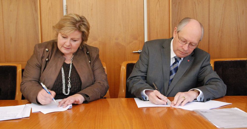 Høyres Erna Solberg og Arbeiderpartiets Martin Kolberg undertegner partienes avtale om DLD.