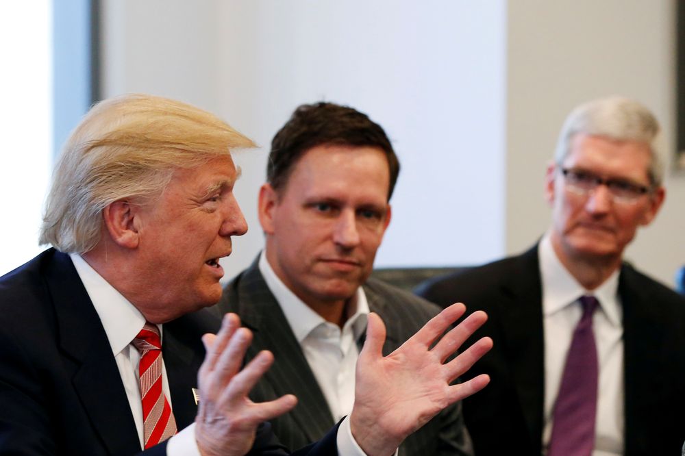 FILE PHOTO - U.S. President-elect Donald Trump speaks as PayPal co-founder and Facebook board member Peter Thiel (C) and Apple Inc CEO Tim Cook look on during a meeting with technology leaders at Trump Tower in New York U.S., December 14, 2016.