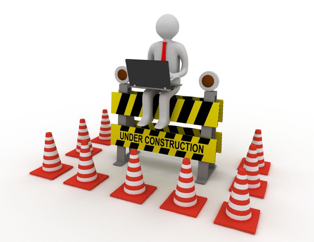 3d worker with laptop is sitting on an Under Construction sign. rendered illustration