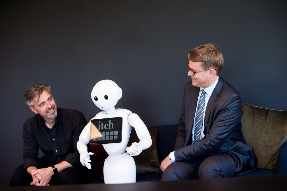 Robotvenner: Advokat og partner i Brækhus, Christian Bendiksen(t.h.) og CEO i Itch, Eirik Norman Hansen, har sammen skrevet en kronikk om eierskap og ansvar for kunstig intelligens – her med roboten Pepper.