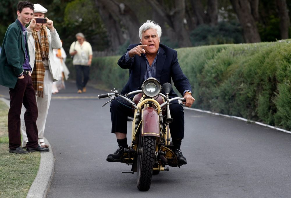 TV personality Jay Leno rides a 1930 Bohmerland motorcycle around the grounds during the Concours d'Elegance at the Pebble Beach Golf Links in Pebble Beach, California, August 17, 2014. The Concours tops a week-long celebration of automobiles and car culture on the Monterey Peninsula. REUTERS/Michael Fiala (UNITED STATES - Tags: SOCIETY TRANSPORT ENTERTAINMENT BUSINESS TPX IMAGES OF THE DAY)