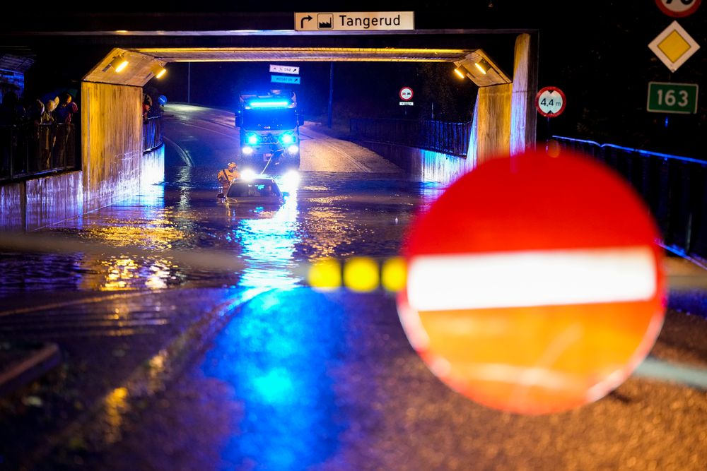 En bil står under vann i undergangen ved Lørenskog stasjon søndag kveld.