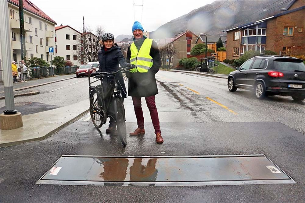 Bildet viser en Actibump fallem i Bergen i 2020, men ikke det samme stedet som sykkelrittet fant sted. I gul vest fylkesordfører Jon Askeland, og på sykkel samferdselspolitker Marthe Hammer, som antakeligvis ikke veltet i fartsdumpen i forbindelse med at bildet ble tatt.