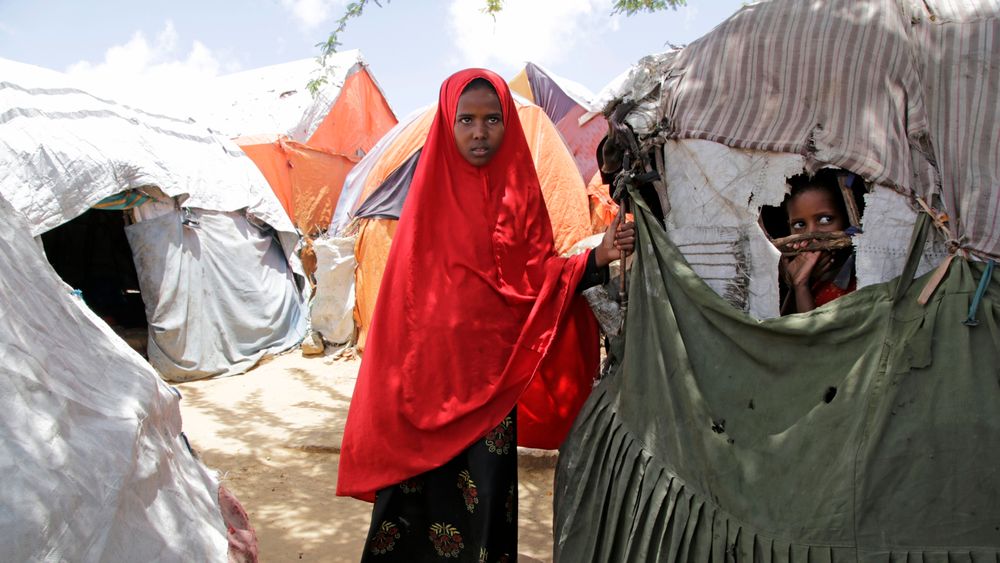 To barn står ved de provisoriske teltene som er satt opp for klimaflyktninger i Mogadishu i Somalia. Familien deres ble tvunget til å flykte da regionen deres ble rammet av den verste tørken på over 50 år tidligere i 2023.