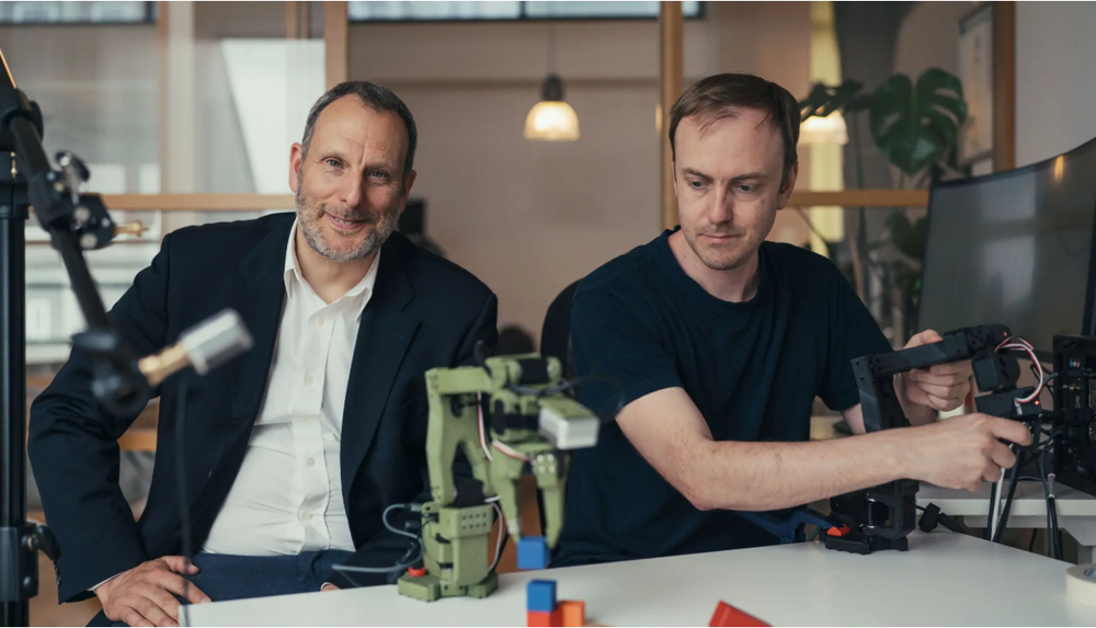 Karim Nouira (t.v.) er daglig leder i Sics AI, og Martin Petterson er senior utviklingsingeniør. På bildet sees også noen av de enarmede robotene Sics bruker til å trene kunstig intelligens.