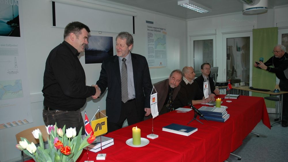 Robert Haugen i AF Gruppen (t.v.) gratuleres av regionveisjef Olav Ellevset. Videre fra venstre sitter prosjektleder Øivind Søvik, Klaus Hansen fra Veidekke og Christian Levinsen fra MT Højgaard.