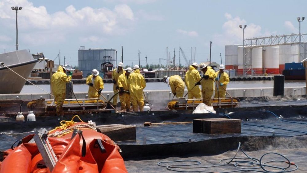 Fotoet er fra mai 2010, da arbeidere i havna i Venice i staten Louisiana vasker olje og dispergeringsmidler av utstyr ved hjelp av høytrykksspyling.