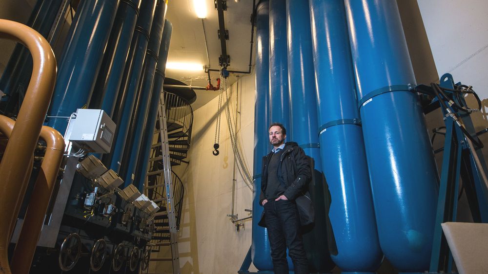 Bjarte Christoffersen står foran de enorme tankene med nitrogen, som driver enorme akkumulatorer til venstre.