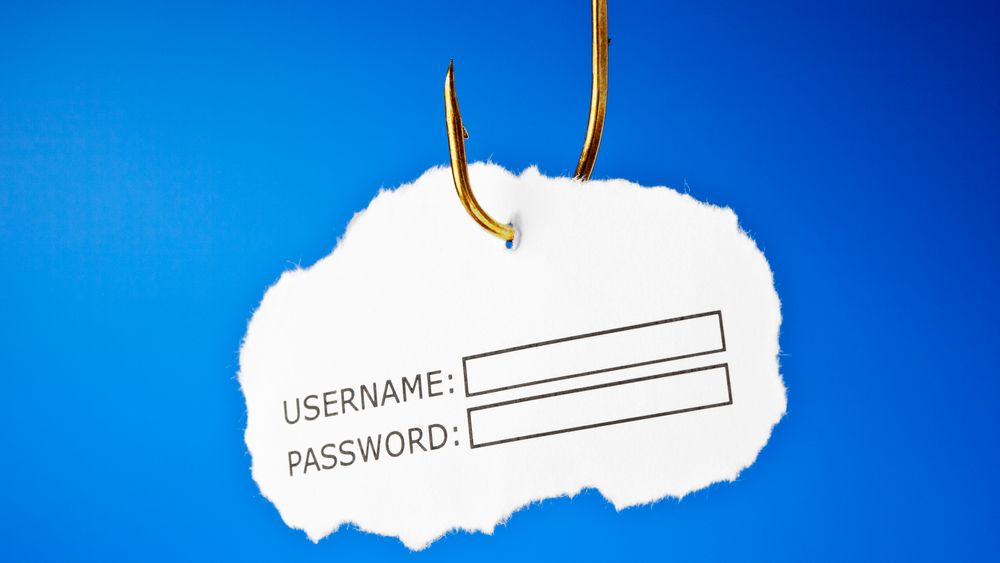 'Username and password' on a fishing hook. Conceptual image about the risk of internet identity theft, also known as 'Phishing'. 