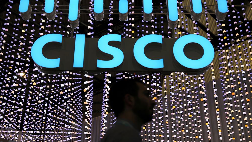 A man passes under a Cisco logo at the Mobile World Congress in Barcelona, Spain February 25, 2019.  ...