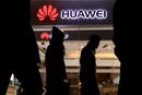 Pedestrians walk past a Huawei retail shop in Beijing Thursday, Dec. 6, 2018. China on Thursday demanded Canada release a Huawei Technologies executive who was arrested in a case that adds to technology tensions with Washington and threatens to complicate trade talks. (AP Photo/Ng Han Guan)