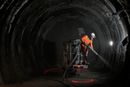 En arbeider sprayer et lag med sement som beskyttelse i en tunnel for radioaktivt avfall i Bure.