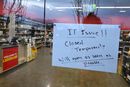 Et skilt varsler kunder om en midlertidig stenging på grunn av IT-problemer i en Liquorland-butikk i Canberra, Australia.