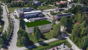 Slik, som bygget midt i bildet, med grønt tak, kan det nye kompetansesenteret bli plassert på NMBU i Ås. Plasseringen er kun en skisse, det er ikke tatt noen beslutning om plassering. <i>Foto: NMBU</i>