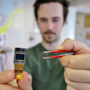 Høy linsetetthet: Oscar Marković holder opp en glassplate som inneholder 4000 mikrolinser laget av et polymer-materiale som deretter er lagt på glasset. <i>Foto: Milan Markovic</i>
