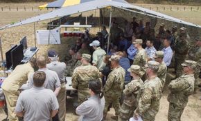 Representanter fra den amerikanske hæren flokker seg rundt skjermene for å se NSM skytes opp og treffe målskipet under Sinkex/Rimpac. <i>Foto:  Capt. Rachael Jeffcoat</i>