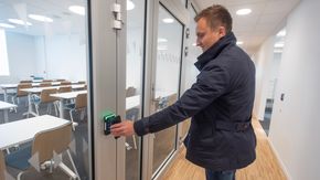Ved bruk av mobilens blåtannteknologi låses dørene opp i bygget. Her viser Tom Erik Lysvik i Schneider Electric hvordan det gjøres. <i>Foto:  Håvard Zeiner</i>