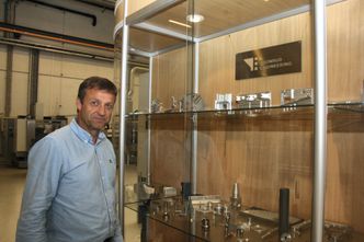 Salgsdirektør Runar Nordby, Tronrud Engineering, foran skryteutstilligen med ulike produkter i titan og andre materialer. Foto: Tore Stensvold