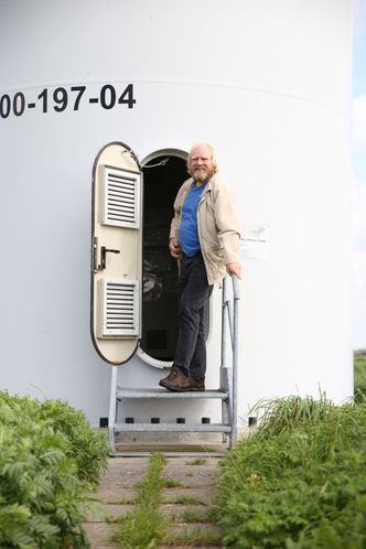 Reinhard Christiansen i Ellhöft, helt nord i Tyskland, viser stolt fram vindmøllen han og de andre innbyggerne på stedet fikk bygget i 2000. Foto: Øyvind Lie