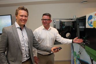 Daglig leder i konsulentselskapet Vivende, Steinar Koffeld (t.v) og Aleksander Mortensen, direktør for Tomra Collection Solutions Digital, ved samme type automater som er utplassert i Australia. Vivende har bidratt med utbetalingsløsninger til forbrukerne. Foto:  Tore Stensvold