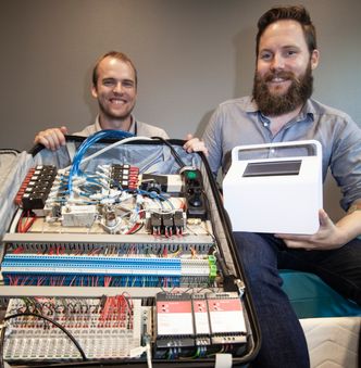 Andreas Smith (til venstre) viser den første prototypen for madassens styringsenhet. Når alt er ferdig tilpasset, skal det få plass i boksen til Arvid Bjerre. Foto:  Alf Bergin