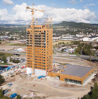 Slik så Mjøstårnet ut noen dager etter at verdensrekorden var sikret i oktober. Svømmeanlegget ligger i det lave bygget til høyre. Foto:  Eirik Urke
