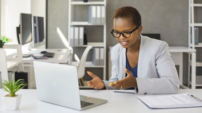Black woman holding webinar or giving online business consultation to client. Female entrepreneur or ...