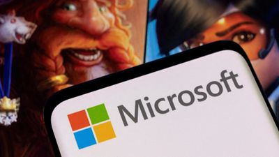 En mobil viser Microsoft logo i bakgrunnen spillfigurer.