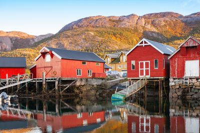 Traditional Norwegian red wooden barns stand on the sea coast. Snillfjord, Sor-Trondelag region, Vingvagen fishing village