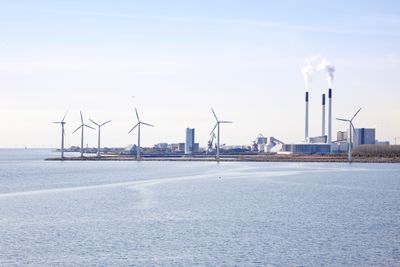 Industrial area and wind turbines on the shore of the Baltic sea