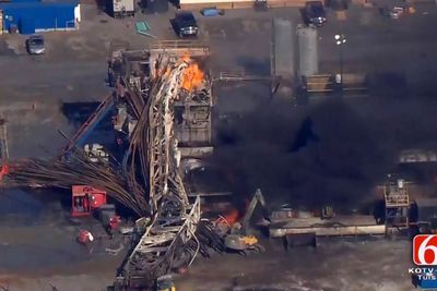 In this photo provided from a frame grab from Tulsa's KOTV/NewsOn6.com, fires burn at an eastern Oklahoma drilling rig near Quinton, Okla., Monday Jan. 22, 2018. Five people are missing after a fiery explosion ripped through a drilling rig, sending plumes of black smoke into the air and leaving a derrick crumpled on the ground, emergency officials said. (Christina Goodvoice, KOTV/NewsOn6.com via AP)