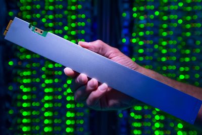 The ruler-shaped PCIe-based QLC Intel SSD D5-P4326 can hold up to 32 terabytes. As part a 1PB solution, it draws just one-tenth the power of a traditional spinning hard drive solution. (Credit: Walden Kirsch/Intel Corporation)