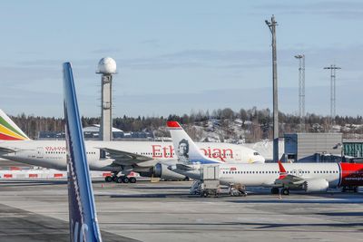Et Boeing 737 Max-8-fly fra Norwegian (SE-RTC) står ved gaten på Oslo lufthavn. Bak står et Boeing 777-260 LR (ET-ANP) fra Ethiopian Airlines.