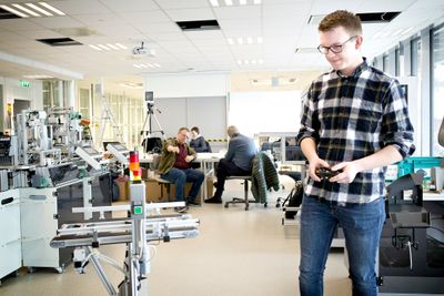 Jan Oddvar Sagedal tester en av to AGV-er i det digitale laboratoriet.