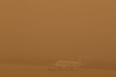 A plane is seen parked on a tarmac during a sandstorm blown over from North Africa known as "calima" at Las Palmas Airport, Canary Islands, Gran Canaria, February 22, 2020. REUTERS/Borja Suarez
