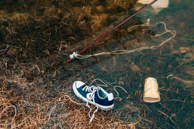 Polluted Beach. Sneakers swim in the river. Rubbish on the river bank. dirty water. World pollution of the planet.