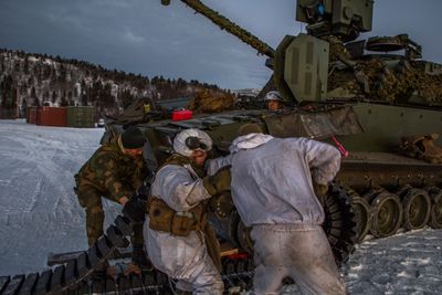 Soldater fra reparasjonslaget Kampstøtteeskadron 6 i Porsanger bataljon bytter belter på en CV90 OPV under en øvelse i slutten av november 2020. Oppklaringsvogna er uten sensormast og -hode, og framstår derfor som en «vanlig» stormpanservogn.