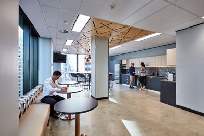 Interior photography of staff in a modern office breakout area with kitchen, a lunc ...