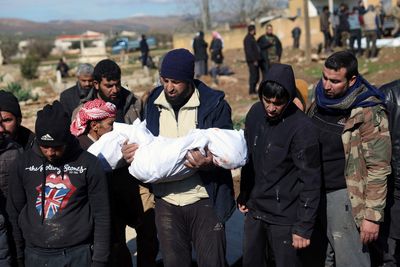 Mourners bury family members who died in a devastating earthquake that rocked Syria and Turkey at a  ...