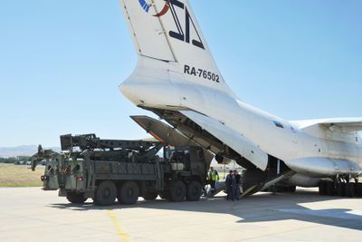 FILE - In this handout photo released by Turkish Defense Ministry, military officials work around a Russian transport aircraft, carrying parts of the S-400 air defense systems, after it landed at Murted military airport outside Ankara, Turkey, on Aug. 27, 2019. Turkey and the United States will aim to smooth out a series of disagreements between the NATO allies when Turkey's foreign minister visits this week but expectations that outstanding issues can be resolved are slim. (Turkish Defence Ministry via AP, File)
