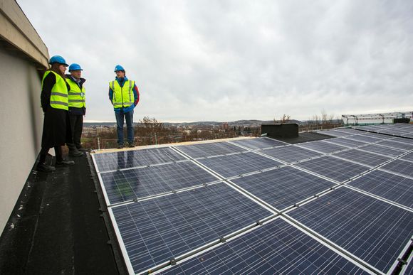 Per Morten Johansen, Flemming Idsøe og Lene Hodge inspiserer solcellene som har blitt satt opp samme dag.