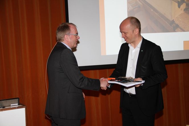 Treentusiast: Landbruks- og matminister Trygve Slagsvold Vedum, til høyre, får overrakt rapporten om urbant trebyggeri av Statsbyggs fungerende direktør for utvikling, Bjørne Grimsrud.